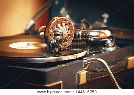 Old record player gramophone needle on record closeup. vintage toning