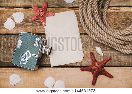 Holiday background with paper, rope and a camera