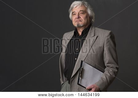 Portrait of serious professor man looking at camera isolated on black background. Handsome teacher of university or colleage in studio.