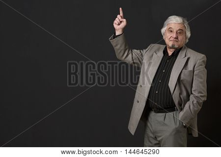 Professor man of university or colleage looking at camera and pointing about ner theory, concept or prove isolated on black background in studio.