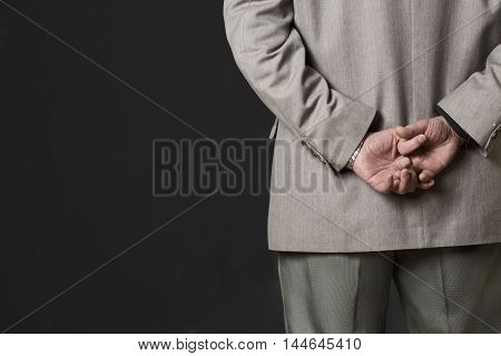 Closeup picture of professor man's hands on back. Academic of university or colleage thinking about new theory, concept or prove in studio.