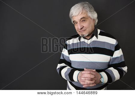 Portrait of handsome professor man of university or colleage isolated on black background. Teacger looking at camera in studio.