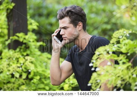 handsome angry man talking on the phone.