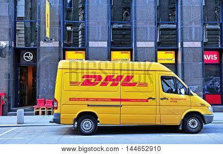 BUDAPEST HUNGARY - MAY 20: Yellow DHL van parked in the street of Budapest city on May 20 2016. DHL Express is a division of the German worldwide logistics company.