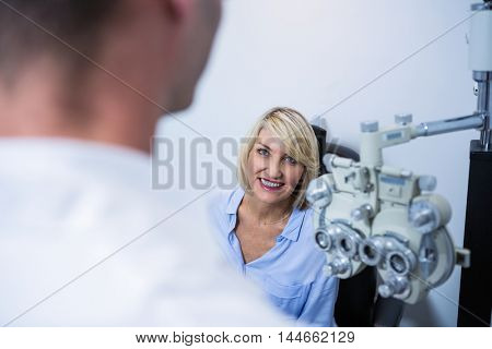 Female patient interacting with optometrist in ophthalmology clinic