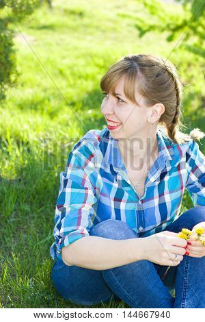 Portrait of a girl in a park on the grass