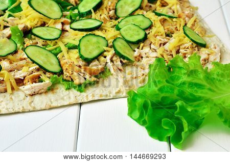 Cooking healthy loaf of pita bread, chicken and fresh vegetables. Diet food