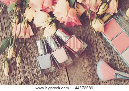 French roses on a wooden background top view. Background of flowers and wood (vintage)