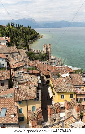 SIRMIONE ITALY - MAY 5 2016: View of colorful old buildings in Sirmione and Lake Garda from Scaliger castle wall Italy