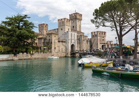 SIRMIONE ITALY - MAY 5 2016: Sirmione - Italian small city on Garda lake with boats and castle