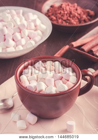 Brown cup of hot chocolate with marshmallow. Toned