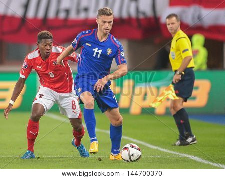 VIENNA, AUSTRIA - SEPTEMBER 5, 2015: David Alaba (Austria) and Nicolae Milinceanu (Moldavia) fight for the ball in an European Championship qualification game.