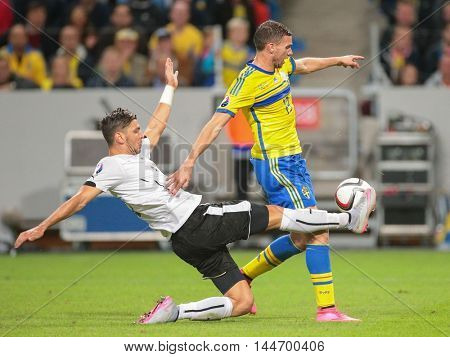 STOCKHOLM, SWEDEN - SEPTEMBER 8, 2015: Aleksandar Dragovic (Austria) and Marcus Berg (Sweden) fight for the ball in an European Championship qualification game.