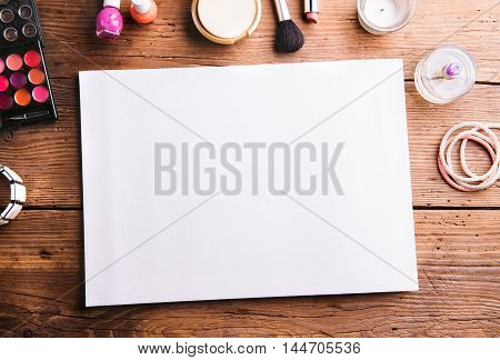 Empty Paper Sheet Laid On Table. Make Up Products.