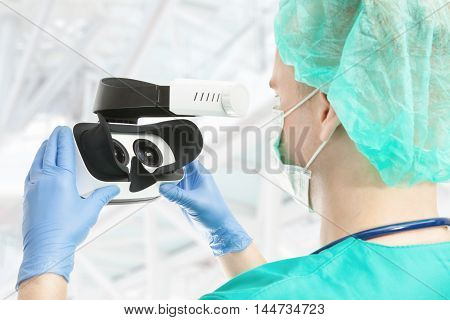 Doctor with virtual reality glasses on white background
