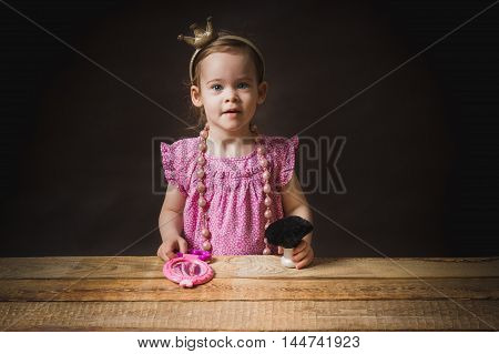 cute little girl with a mirror and brush