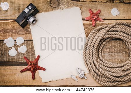 Holiday background with paper, rope and a camera