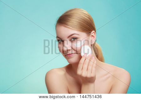 Woman Removing Makeup With Cream And Cotton Pad