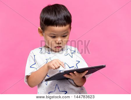 Asian little boy using dgital tablet