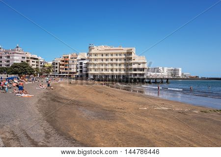 EL MEDANO SPAIN - JULY 16: Tourist relaxing at el Medano beach on july 16 2016 in El Medano Tenerife Canary islands Spain .