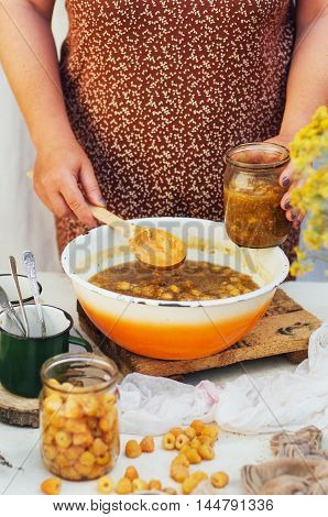 Raspberries Jam. Female Hand Making Jam, On A Rustic White Table