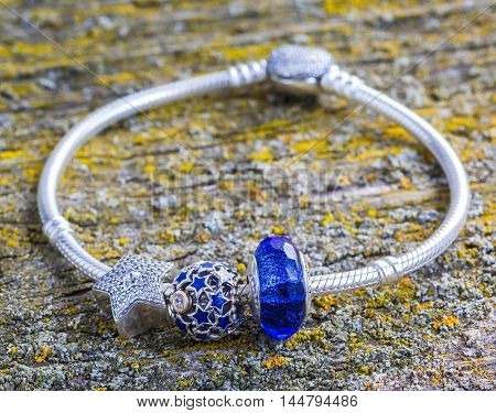 jewelry bracelet women on an old wooden surface modern fashion charms jewelry macro