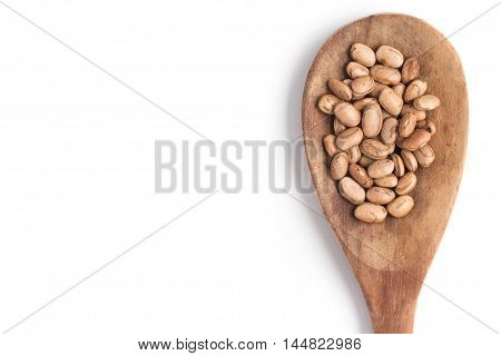 Carioca Beans into a spoon in white background