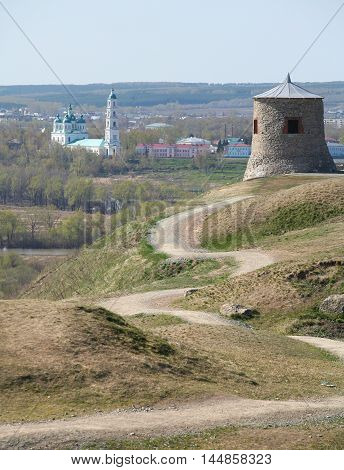 Tower of ancient Bulgar fortress on a high cliff on the banks of the Kama River sunny spring day