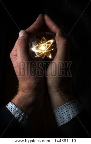 Holding atom in fortune teller magic crystal ball