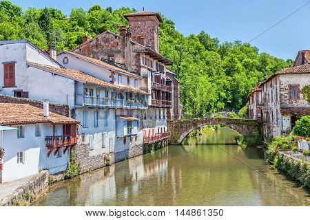 Arc bridge over the river La Nive de Beherobie in small town Saint-Jean-Pied-de-Port Aquitaine France