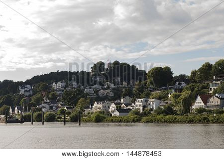 View from the Elbe to the luxury residential district of Hamburg Blankenese with small beach