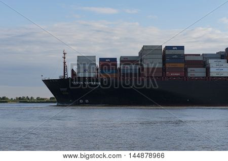 Hamburg, Germany - August 18, 2016: Container ship sails on the Elbe towards Hamburg harbor on August 18, 2016, in the Germany Hamburg