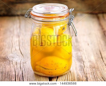 Preserved lemons with sea salt and spices. Moroccan cuisine. Vintage style.