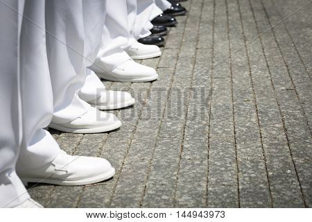 NEW YORK MAY 27 2016: Close up of white dress shoes worn by US Navy personnel during the re-enlistment and promotion ceremony at the National September 11 Memorial site during Fleet Week 2016.
