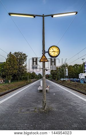 ESCHBORN GERMANY - AUG 27 2016: people sitting at a bench and wait for the next train or S-Bahn in the train station Eschborn.