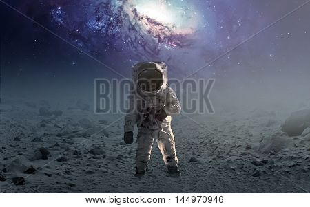 Astronaut walking on an unexplored planet. Elements furnished by NASA