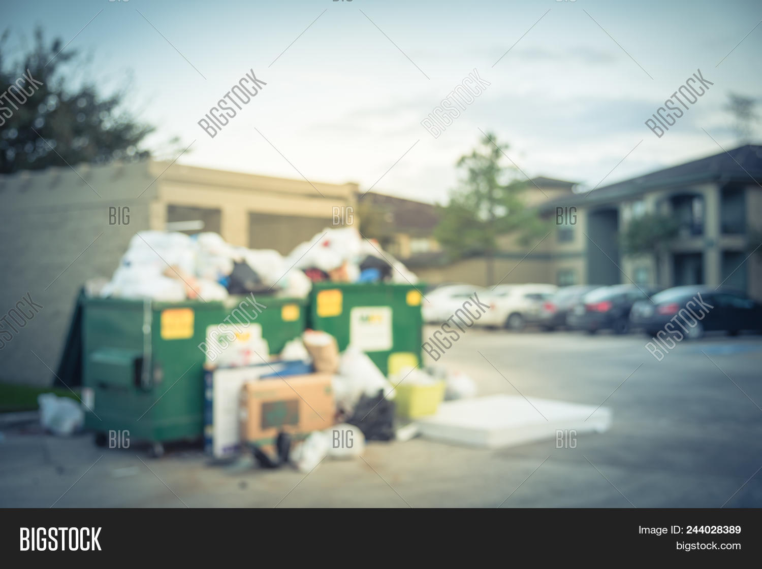 Vintage Blurred Image Photo Free Trial Stock Blurred An Overflowing Dumpster At Apartment Building Yard In Humble Texas Us Overfill And On Ground Full Of Household Waste Plastic Bag Mattress