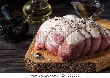 Raw Pork Chop Marinated Meat Roll Wrapped With Twine Made Of Jute, With Coarse Sea Salt, Pepper, Her