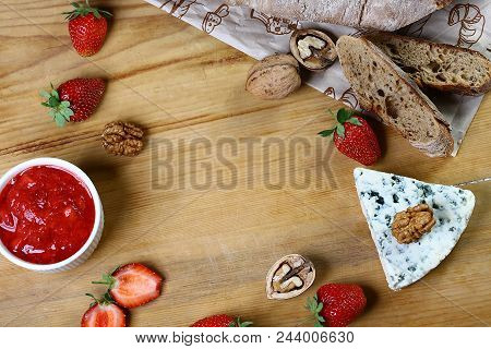 A Creamy, Buttery, Salty Blue Cheese From Northern Italy With Strawberry Sauce, Bread, Walnut On A W