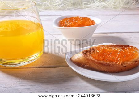 Morning Breakfast Set With Orange Jam On Bread Toast And Juice In Glass