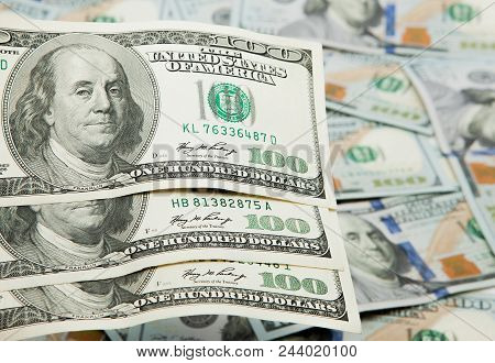 Old One Hundred Dollars Against The Background Of The New Ones.