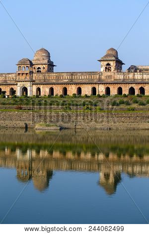 Jahaz Mahal , Ship Palace And Blue Water Lake In Sunrise. Mandu, Madhya Pradesh, India. Old Indian A