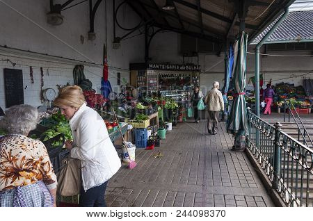 Porto, Portugal - October 10, 2010: People Buying Products At The Traditional Bulhao Market (mercado