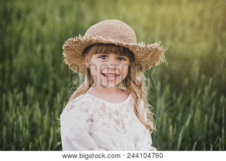 Happy Little Girl On Green Wheat Field