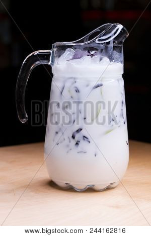Ayran - liquid drink made from yogurt in ransparent glass cup and green apple