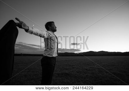 Monochrome Image Of Successful Business Man In Elegant White Shirt And Tie With His Arms Outspread S