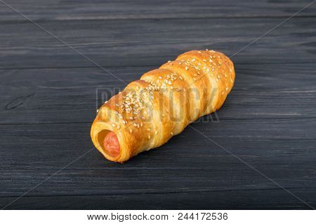 Sausages Wrapped In Puff Pastry. Sausages Wrapped In Puff Pastry. Sausages In A Dough On A Wooden Ba