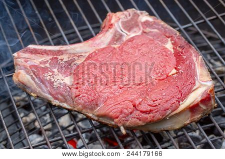 Close-up Of A Raw Beef Rib On A Barbecue Grill
