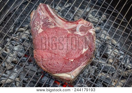 Close-up Top View Of A Raw Beef Rib On A Barbecue Grill