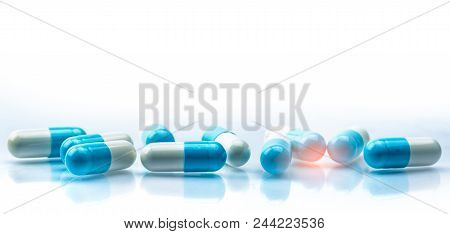 Blue And White Capsules Pill Spread On White Background With Shadow And Copy Space. Global Healthcar